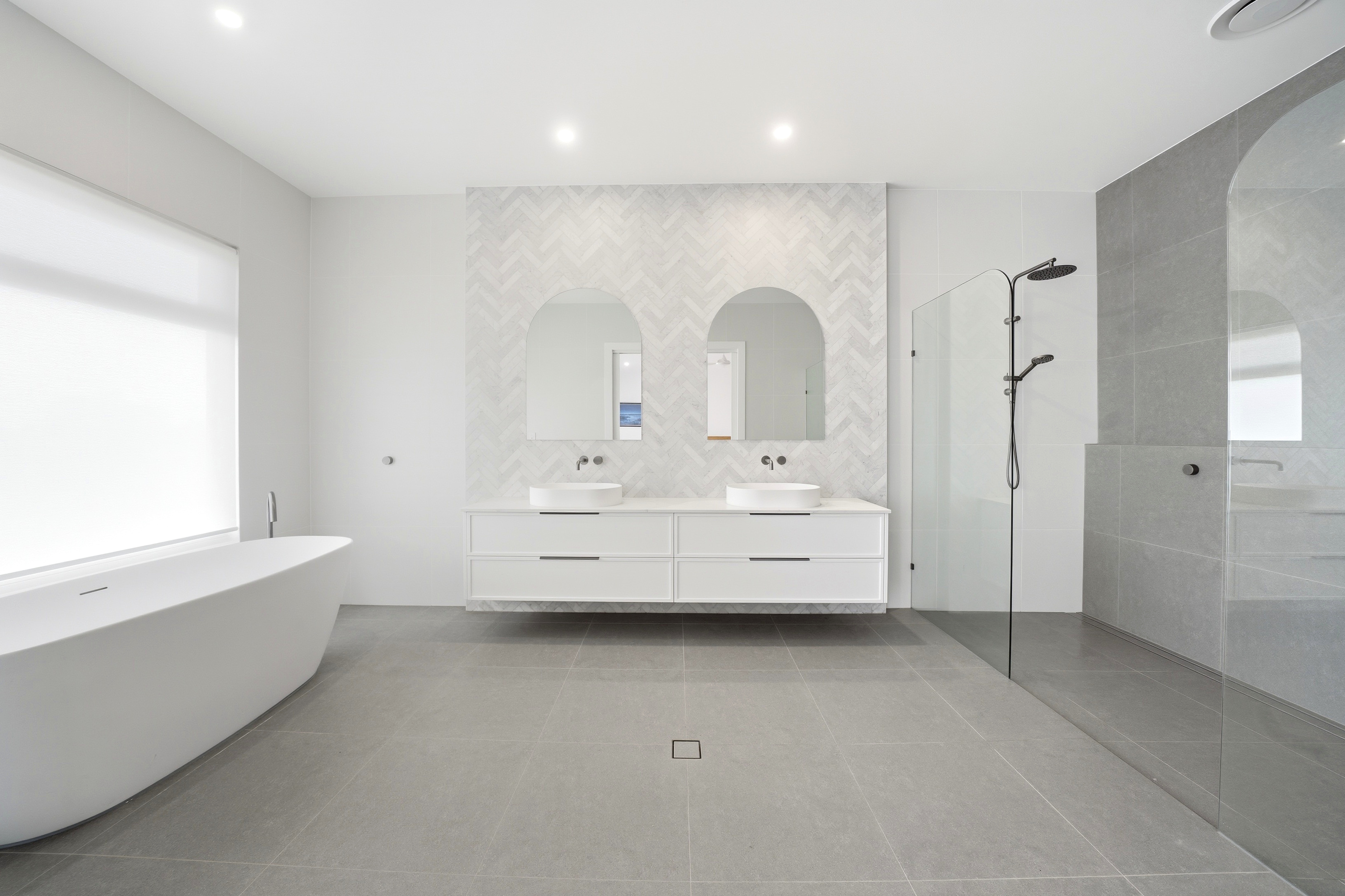 Bathroom with dual vanities and freestanding bath