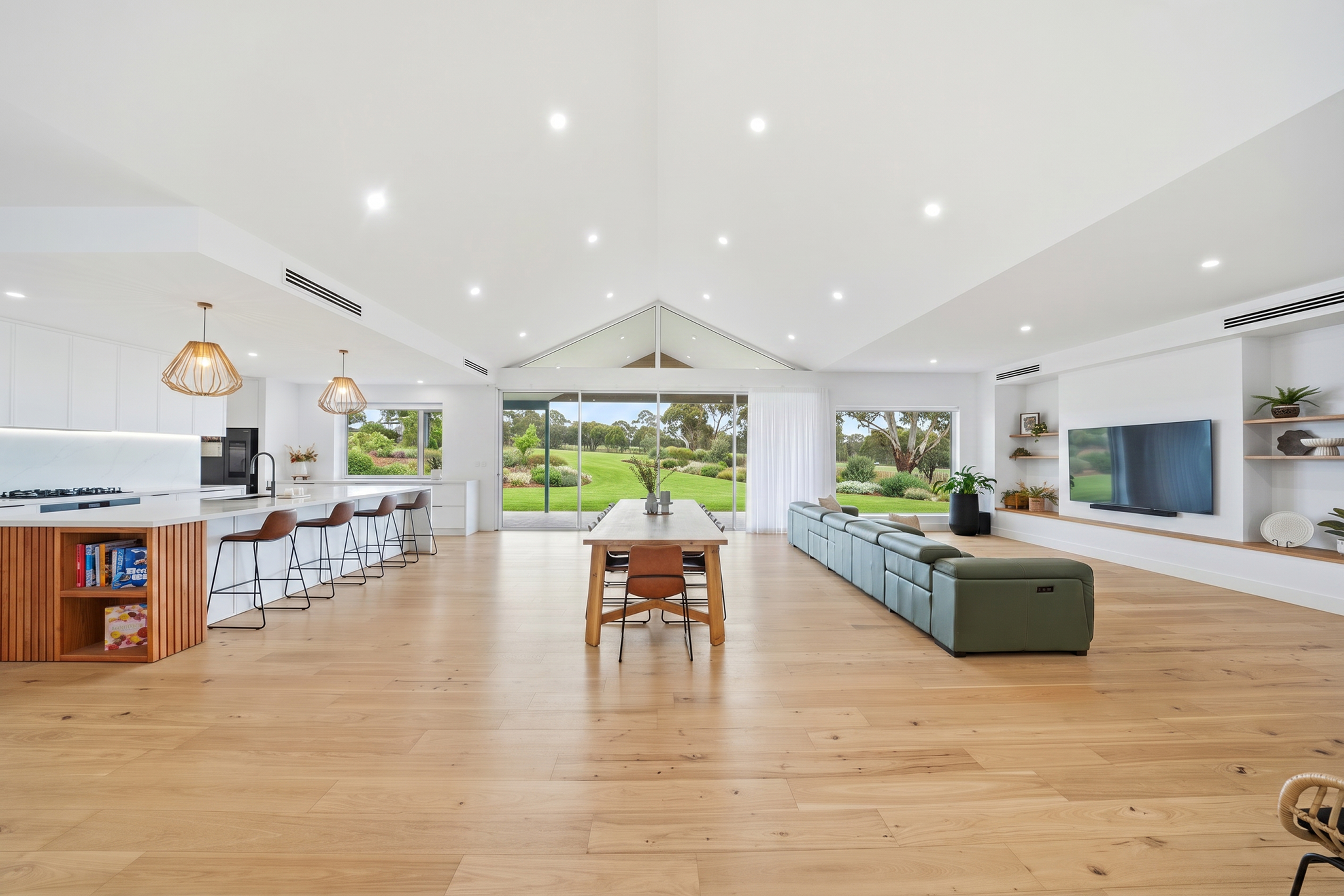 Open-plan kitchen, dining and living looking out to the pool and garden